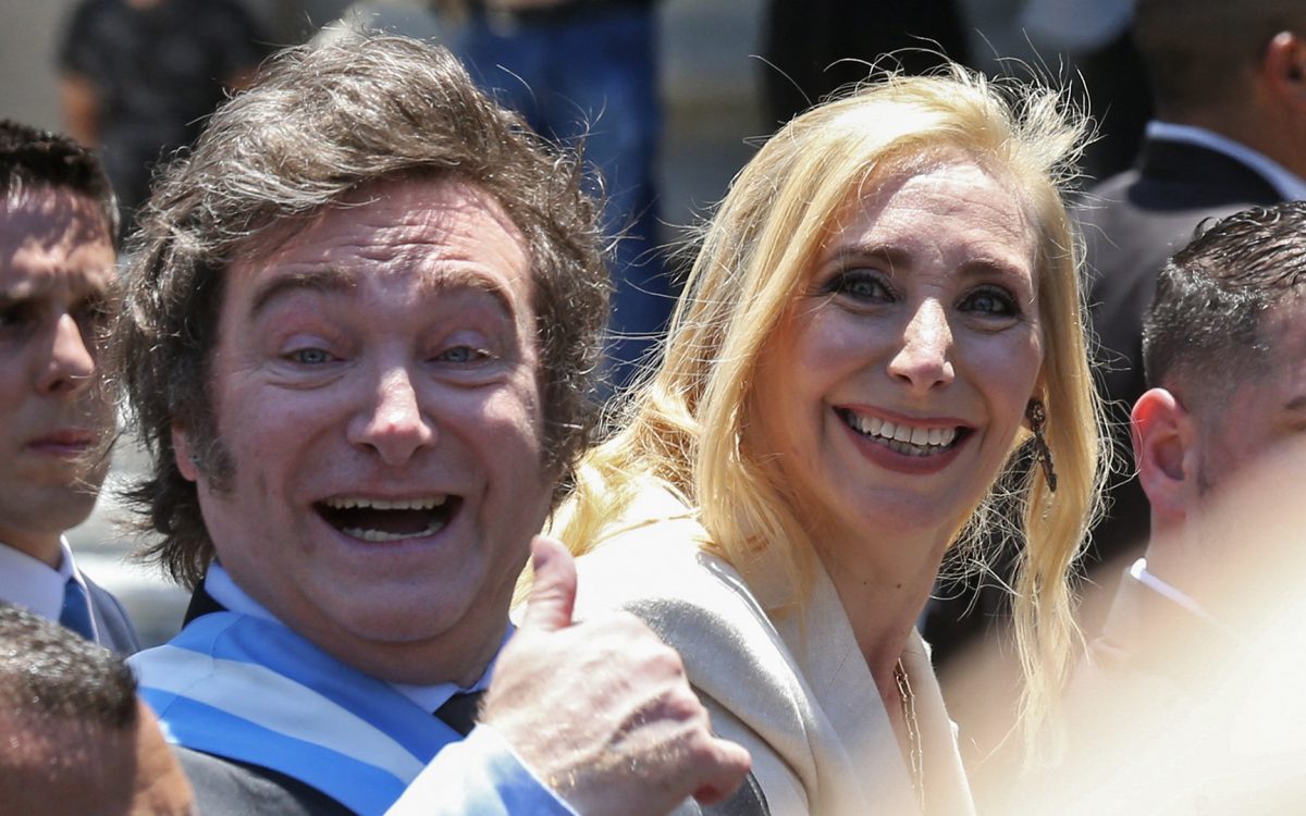 Argentina's new president Javier Milei (L) and his sister Karina Milei head to Casa Rosada Presidential Palace in an open car after he was sworn in during an inauguration ceremony at the Congress in Buenos Aires on December 10, 2023. Libertarian economist Javier Milei was sworn in Sunday as Argentina's president, after a resounding election victory fuelled by fury over the country's economic crisis. (Photo by Cezaro DE LUCA / AFP)